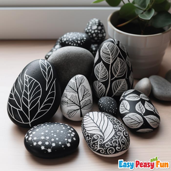 Rocks painted black with white line art